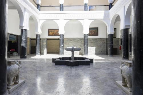 达赫拉Hôtel Calipau Riad Maison d'Hôtes的博物馆,在房间中间有一个喷泉