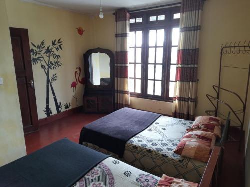 努沃勒埃利耶Green Villa的一间卧室配有两张床和镜子