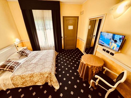 卡萨诺韦MOTEL Malpensa INN & Hotel-Airport的配有一张床和一台平面电视的酒店客房