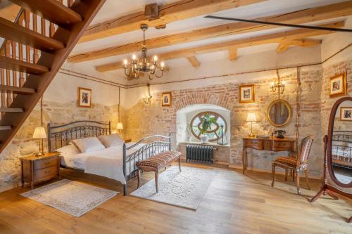 卢切内茨Galicia Nueva, castle hotel的一间卧室设有一张床和石墙