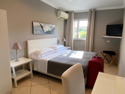 罗马欧瑞狄荣马酒店的一间卧室配有一张床和一个红色的行李箱