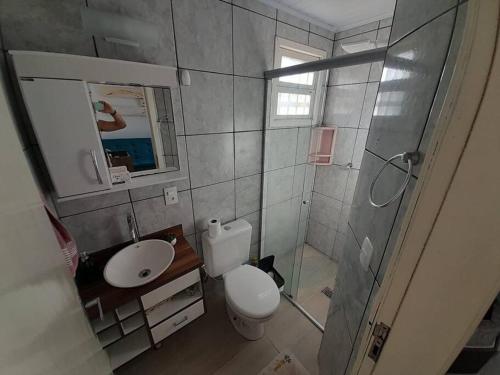 卡庞达卡诺阿Apartamento em Capão Novo com piscina的浴室配有卫生间、盥洗盆和淋浴。
