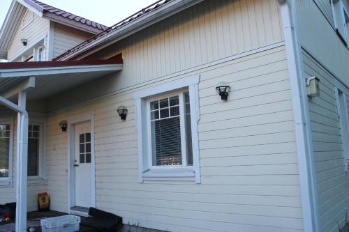 OulunsaloOulunsalo Apartment的白色房子的一侧有窗户