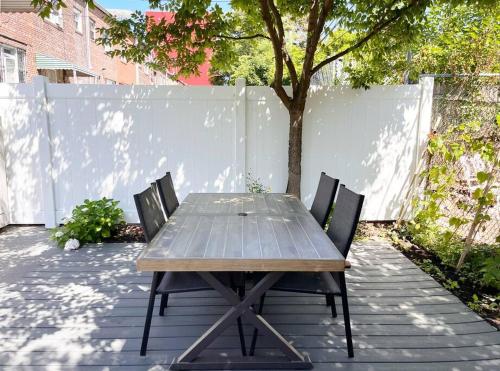 布鲁克林New Cozy Modern Minimalist Stay in Brooklyn at Rem-Casa的天井上配有一张木桌和两把椅子