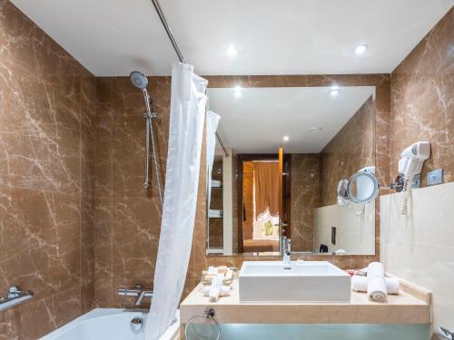 扎赫勒Grand Kadri Hotel - History Marked by Cristal Lebanon的带浴缸、水槽和浴缸的浴室