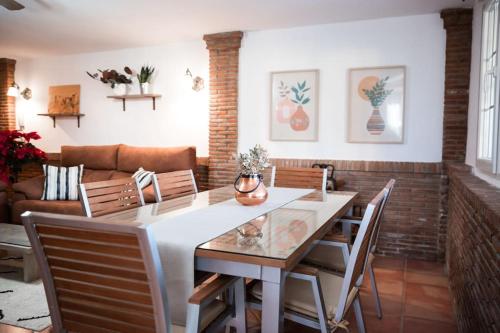 拉苏维亚Casa espaciosa cerca de Monachil的一间带桌椅和沙发的用餐室