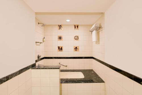 印多尔印多尔柠檬树酒店的白色瓷砖浴室设有水槽