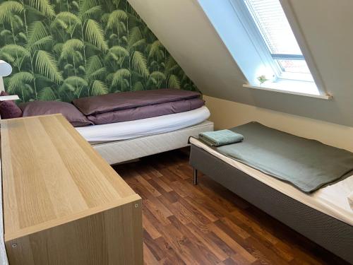 罗斯基勒Country flat的小房间设有两张床和窗户