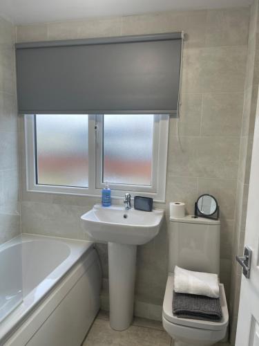 安布尔Oyster Retreat的一间带水槽和卫生间的浴室以及窗户。