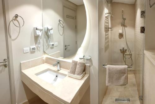 赫尔格达Mangroovy Gouna 1 BR apartment的一间带水槽、镜子和淋浴的浴室