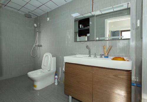ShuijiaoSunny Apartment, minutes to beach的一间带水槽、卫生间和镜子的浴室