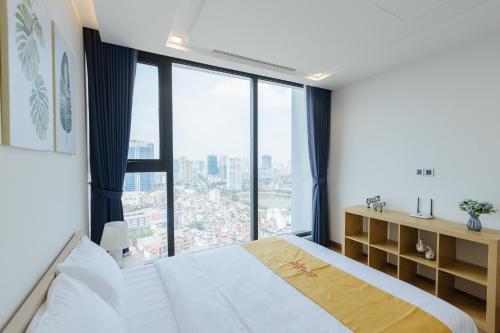 河内Royal Serviced apartment Vinhomes Metropolis的一间卧室设有一张床和一个大窗户