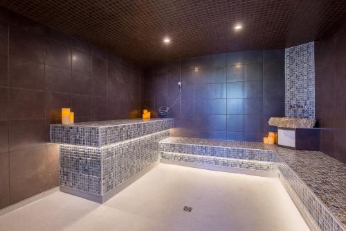 布罗姆湖Hotel Lac Brome的浴室设有2个水槽和蓝色瓷砖浴缸。