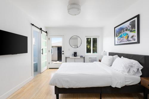 洛杉矶Sunny Studio near Culver City的白色卧室设有一张大床和镜子