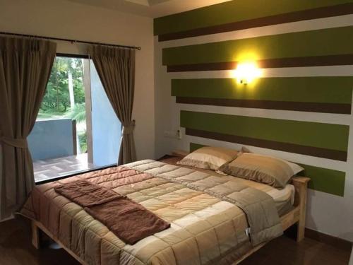 Ban Khao NoiThe shark resort ปราณบุรี的一间卧室配有一张带条纹墙的床