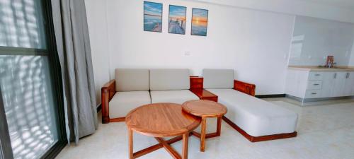 南迪Ocean Breeze Apartment的客厅配有白色的沙发和桌子