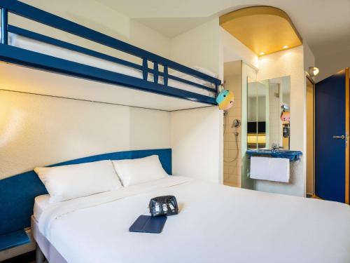 格拉茨格拉茨城宜必思快捷酒店的酒店客房,配有一张带时钟的床
