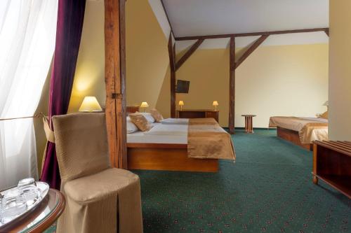 布拉格威廉酒店的酒店客房,配有两张床和椅子