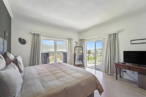 豪特湾Seaside Villa - 1 La Mer的一间卧室配有一张床、一台电视和一个窗口