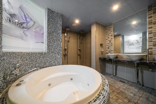 釜山MU HOTEL的一间带大浴缸和两个盥洗盆的浴室