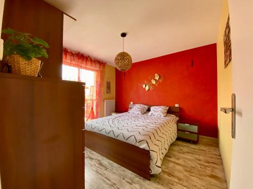 加普Découvrez le charme au cœur de Gap的一间卧室设有红色墙和一张床
