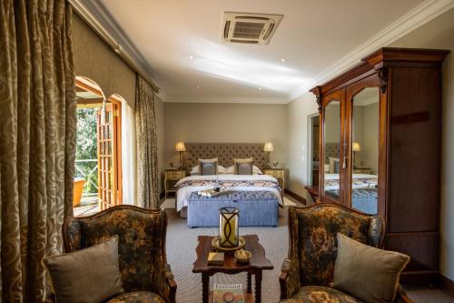 克拉伦斯Andes Clarens Guesthouse的酒店客房,配有一张床和两把椅子