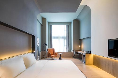 上海上海虹桥中心爱琴海亚朵S酒店的配有一张床和一张书桌的酒店客房