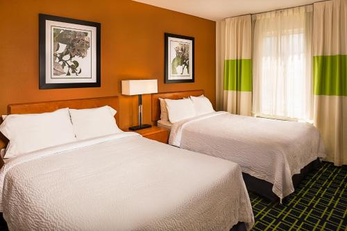 皇后区纽约拉瓜迪亚机场/芙拉世迎费尔菲尔德万豪酒店的酒店客房设有两张床和窗户。