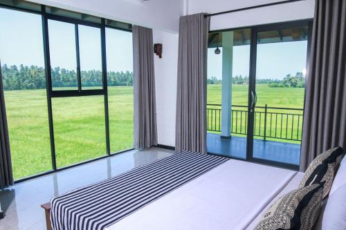 蒂瑟默哈拉默Oragan Resort的客房设有大窗户、一张床和椅子