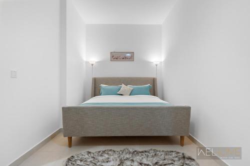 阿布扎比WelHome - Luxury Apt Close to Yas Water and Ferrari World的一间卧室配有一张带蓝色枕头的床