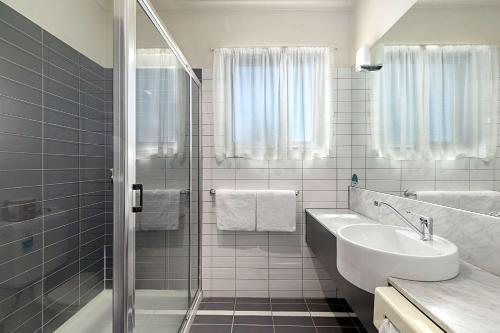 米尔迪拉米尔迪拉格兰德品质酒店的带淋浴和盥洗盆的白色浴室