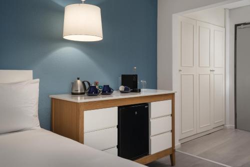 开普敦普罗蒂亚万豪酒店 - 开普敦海点店的一间卧室配有一张床和一张带醚的书桌