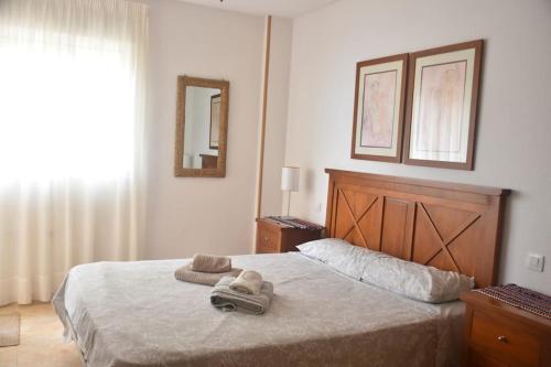 拉曼加戴尔马尔梅纳Apartment Jardines Del Mar的一间卧室配有一张床,上面有两条毛巾