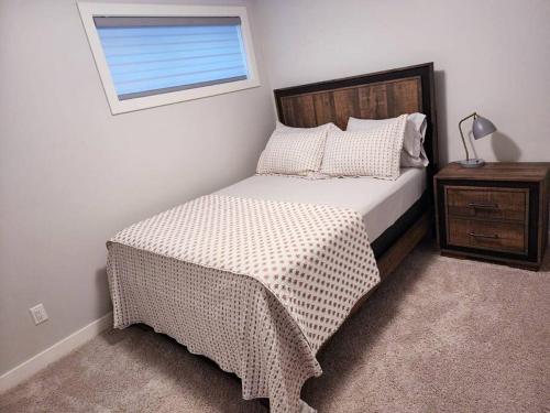 埃德蒙顿Deluxe 2 bedroom suite with*Netflix/Cable/Prime的一间卧室设有一张床和一个窗口