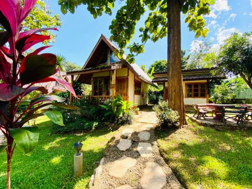 Ban ThamAt Home Chiang Dao, Pooch Lovers的前面有一张野餐桌的房子