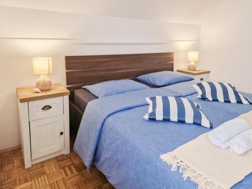 卡特兹奥布萨维Aparthouse SUPREME with Terme Catez Swimming Pools Tickets的卧室内的两张床,配有蓝色的床单和枕头