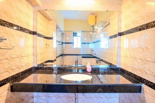 比纳里姆'Golden Sunset' 3bhk beach villa的一间带水槽和镜子的浴室