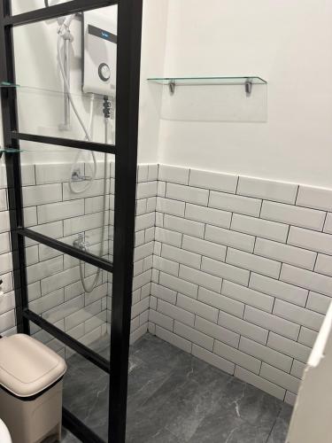 达沃市Privée Homestay的白色瓷砖浴室设有卫生间和淋浴。