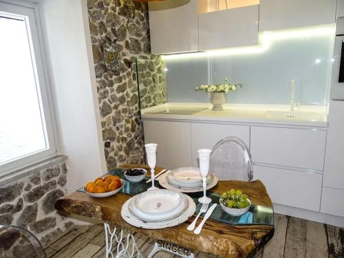 切法卢Casa Vela的厨房配有带盘子和水果的桌子