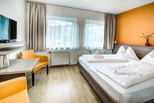 萨尔茨堡霍夫曼酒店的酒店客房设有一张大床和一张桌子。