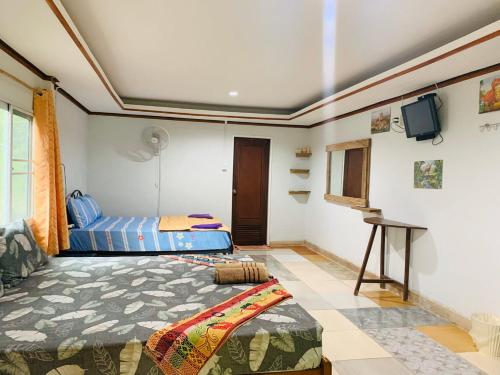 Siboya拉查日落度假酒店的一间卧室配有一张床和一台平面电视