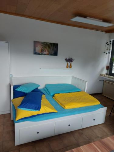 韦塞尔Ferienwohnung W.Esel的一间卧室配有蓝色和黄色枕头的床