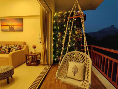 卡尔贾特‘The Mountain Majesty’: cozy 1 bhk apartment的客厅配有秋千和圣诞树