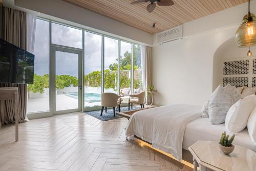 北马累环礁Malahini Kuda Bandos Resort的一间带大床的卧室和一间客厅