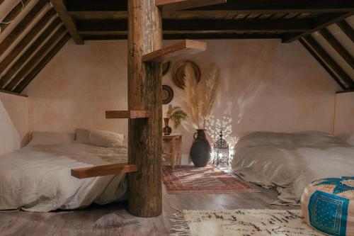 仓敷仓敷挫若旅馆的一间卧室设有两张床和一根柱子