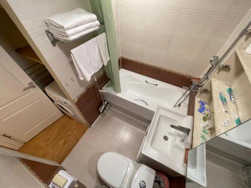 乌兰巴托Two-Bedroom Apartment的浴室配有盥洗盆、卫生间和浴缸。
