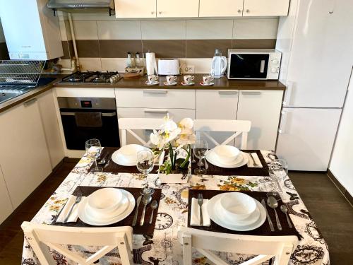 布拉索夫Relaxing Coresi Place的厨房配有带白色板子和椅子的桌子