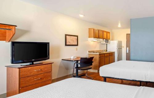 科罗拉多斯普林斯Extended Stay America Select Suites - Colorado Springs - Airport的小型酒店客房配有床和电视。