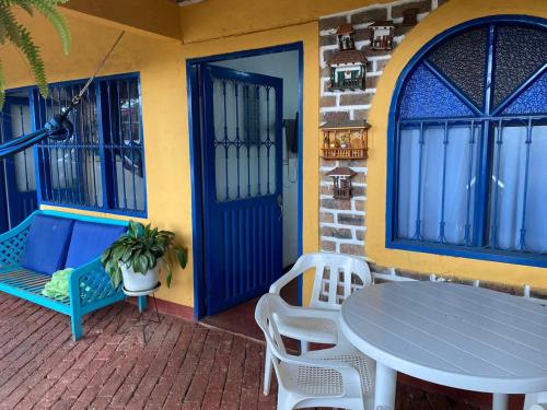 莫尼基拉DinoAgro Potrero Grande的一个带桌椅的庭院和一扇蓝色的门