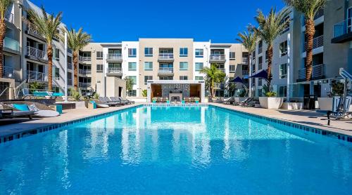 尔湾Global Luxury Suites Irvine的一座棕榈树和建筑的大型游泳池